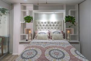 a bedroom with a large bed with a large headboard at Casa Ramos Salamanca - Airport pick up and drop off service - Homestay in Lima