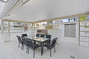 uma sala de jantar com mesa e cadeiras em Modern 2BR Apt next to SouthBank Free Wifi & Pool em Brisbane