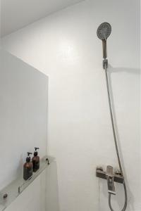 a shower with a hose attached to a wall at Blauset Two in General Luna