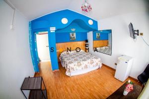 um quarto com uma cama num quarto azul em Apart Hotel Sonoma em Viña del Mar