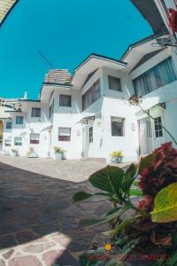 um grande edifício branco com flores em frente em Apart Hotel Sonoma em Viña del Mar