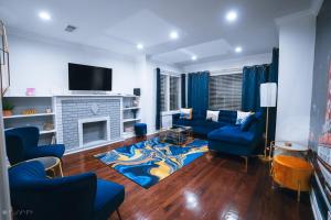 a living room with blue couches and a fireplace at The Blue Golden Luxury Modern 3- Bedroom Apartment in Chicago in Chicago