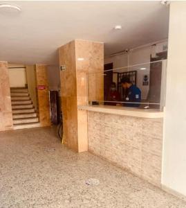 a man standing behind a counter in a building at Apartaestudio Vista azul rodadero Mara 502 in Santa Marta