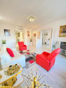 a living room with red and white furniture at Penthouse in the castle in Budapest