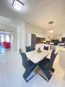 a kitchen and dining room with a table and chairs at Penthouse in the castle in Budapest