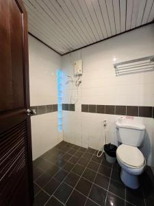 a bathroom with a toilet and a blue window at Dream Valley Resort, Tonsai Beach in Tonsai Beach