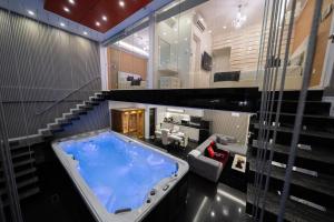 a large tub in a room with a living room at Luks Lofts Hotel & Residences in Batangas City