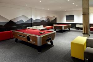 a billiard room with a pool table and couches at Delta Hotels by Marriott Mont Sainte-Anne, Resort & Convention Center in Beaupré