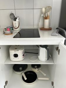 a kitchen shelf with a counter top with utensils at horizon suite 25-11 in Sepang