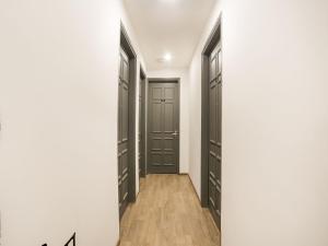 a walk in closet with black doors and wood floors at Super Townhouse 213 Artemis Hospital Near Appu Ghar in Gurgaon