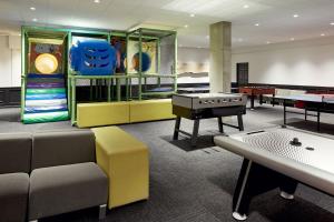 a waiting room with tables and ping pong tables at Delta Hotels by Marriott Mont Sainte-Anne, Resort & Convention Center in Beaupré