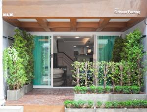 a front door of a building with plants at Reach Patong beach in one minute in Patong Beach