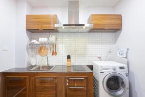 a kitchen with a sink and a washing machine at Reach Patong beach in one minute in Patong Beach