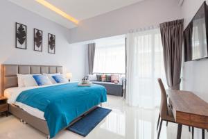a bedroom with a blue bed and a desk at Reach Patong beach in one minute in Patong Beach