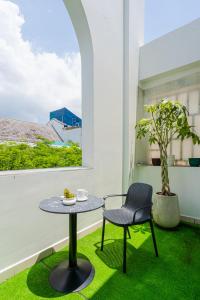 a table and chair on a balcony with a window at La Serena Boutique Hotel in Ho Chi Minh City