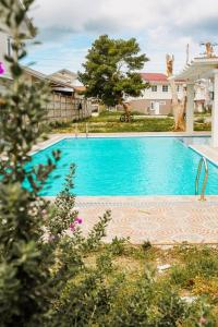 a large blue swimming pool in a yard at Villa Izabella in Panglao Island in Dauis