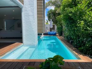 a swimming pool in the backyard of a house at Luxury Beachside Retreat in Papamoa