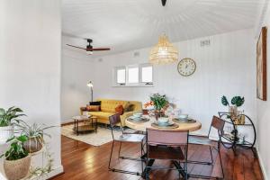a living room with a table and chairs at Vintage 2BR CBD Apartment w/River View in Perth