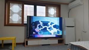a flat screen tv sitting in a living room at dakwan stay in Seoul