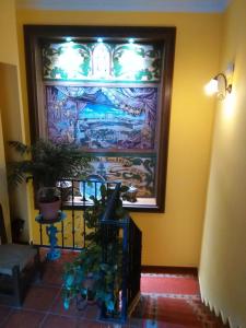 a hallway with a wall with a painting on it at Hotel Casa Rural San Antón in Chinchón