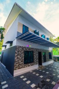 a house with a blue roof at RAGAM RESORT in Alleppey