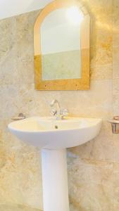 a white sink in a bathroom with a mirror at Sanasuma Villa in Bentota +62 photos