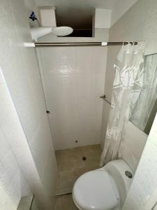 a small bathroom with a toilet and a shower at Castellares La Puebla Habitación y estudio en el centro in Ayacucho