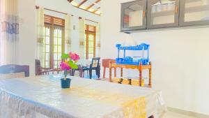 a room with a table with a vase of flowers on it at Sanasuma Villa in Bentota