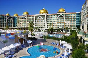 a hotel with a pool in front of a building at Alan Xafira Deluxe Resort & Spa-ULTRA ALL INCLUSIVE in Alanya
