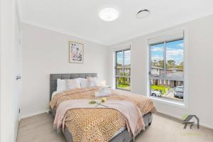a bedroom with a bed and a large window at Vivid House in Marsden Park in Marsden Park