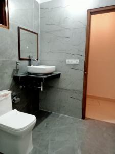 a bathroom with a white toilet and a sink at Patli Fort Hills Estate in Kota Bāgh