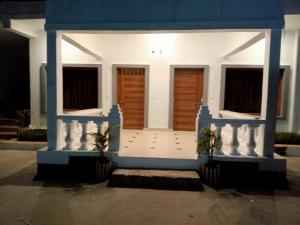 una casa azul y blanca con dos puertas en Patli Fort Hills Estate en Kota Bāgh