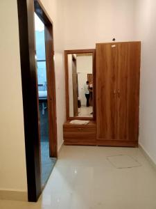 a bathroom with a mirror and a wooden cabinet at Patli Fort Hills Estate in Kota Bāgh