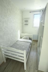 Habitación pequeña con cama y ventana en Élégant appartement bord de Seine, en Montereau-Fault-Yonne