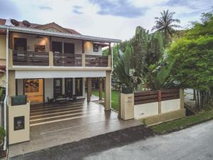una casa con porche y terraza en Kuah Town - Villa Indah, en Kuah