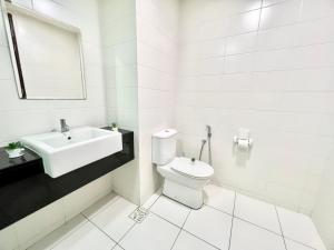 a white bathroom with a sink and a toilet at K 1-5Pax Trefoil Cozy Home Setia Alam TV Wifi SCCC in Shah Alam