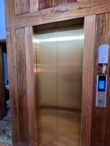 an elevator in a building with a glass door at Happy Hotel & Spa in Sapa