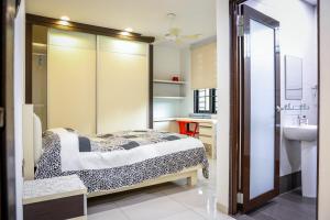 1 dormitorio con cama y lavamanos en Kuah Town - Villa Indah, en Kuah