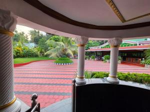 a view of a patio with columns and a building at GB 25 Cottage in Trivandrum