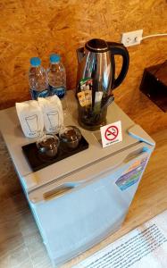 a tray with a tea kettle on top of a laptop at เรินนายหัว by KOYAD 