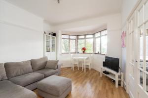a living room with a couch and a table at Beautiful 2 Bedroom Flat on Street Lane in Moortown