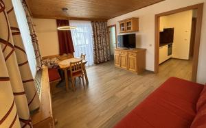 a living room with a kitchen and a dining room at Ferienwohnungen Passrugger in Eben im Pongau