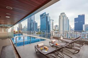 uma varanda com vista para o horizonte da cidade em Adelphi Suites Bangkok - SHA Extra Plus em Bangkok