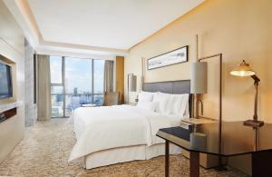 a hotel room with a large bed and a window at The Westin Ningbo in Ningbo