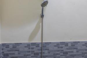 a shower head on the side of a wall at Penginapan Asri in Mataram