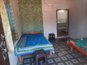 a bedroom with a bed in a room with a window at PALASH Pahar Resort in Jhalida