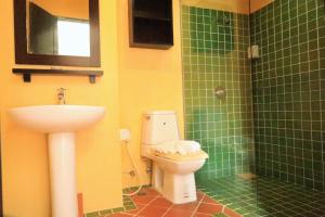 a bathroom with a toilet and a sink at Harmony Patong Hotel in Patong Beach