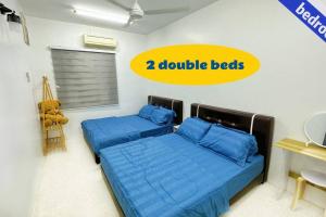Postel nebo postele na pokoji v ubytování Alor Setar City Homestay