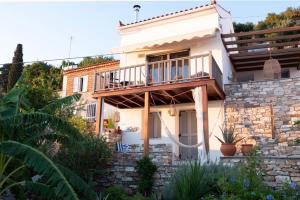 a villa with a balcony in a garden at Kleine Villa mit Meerblick, Samos, Griechenland in Samos