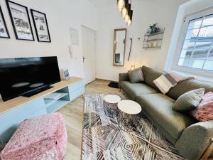 a living room with a couch and a tv at Ferienwohnung beach, ca 150 m zum Strand in Warnemünde